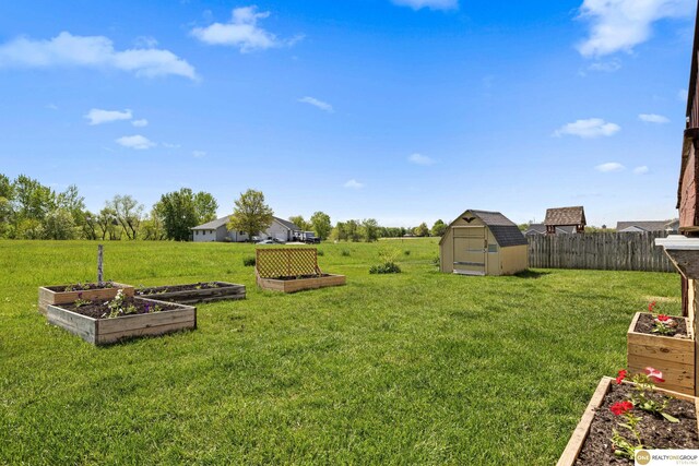 554 Shawnee Blvd, Tecumseh, NE 68450 - view of yard featuring a garden, a shed, and an outbuilding