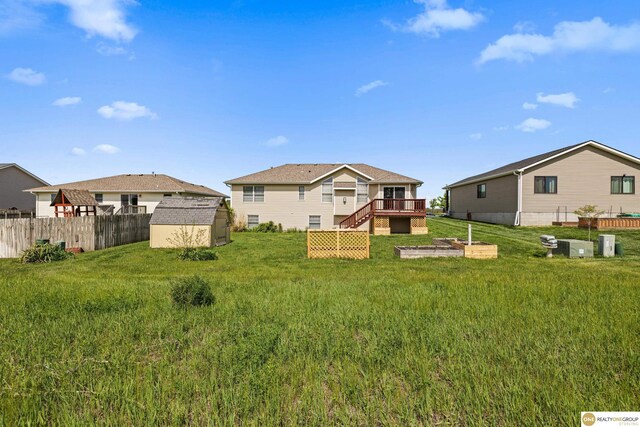 554 Shawnee Blvd, Tecumseh, NE 68450 - back of property featuring a storage unit, an outbuilding, a deck, and stairs