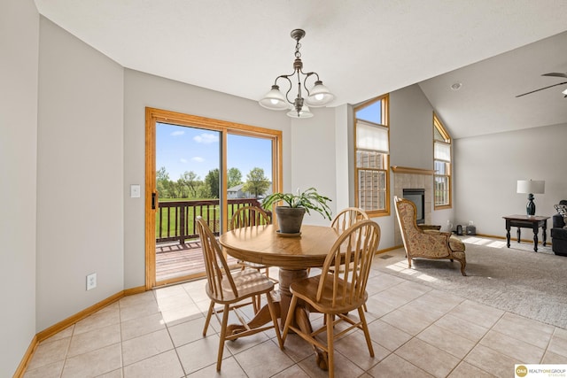 554 Shawnee Blvd, Tecumseh, NE 68450 - dining area with light tile patterned flooring, a chandelier, baseboards, vaulted ceiling, and a tile fireplace