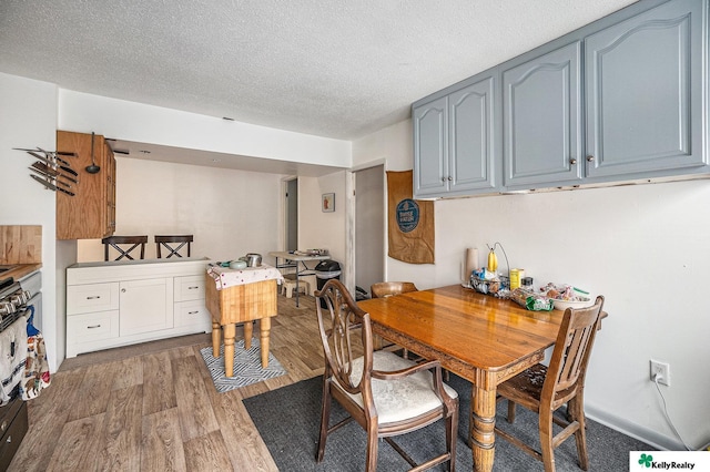 dining area featuring a textured ceiling and wood finished floors