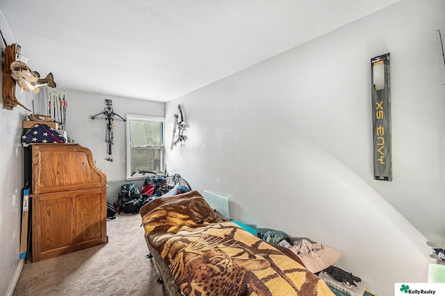 carpeted bedroom featuring baseboards