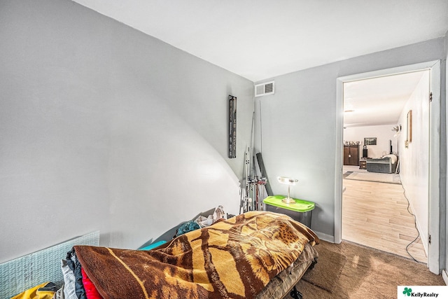 carpeted bedroom featuring visible vents