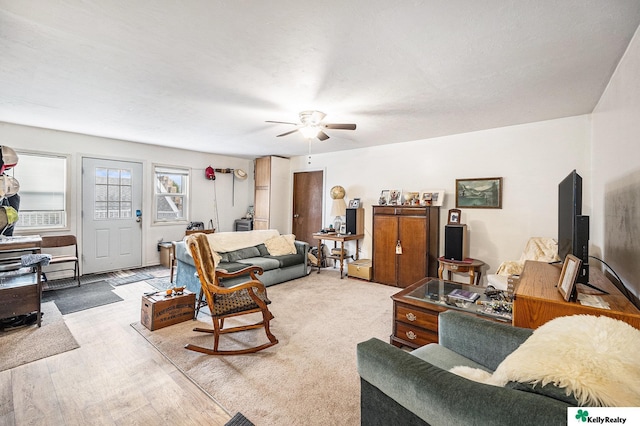 living room with ceiling fan and wood finished floors