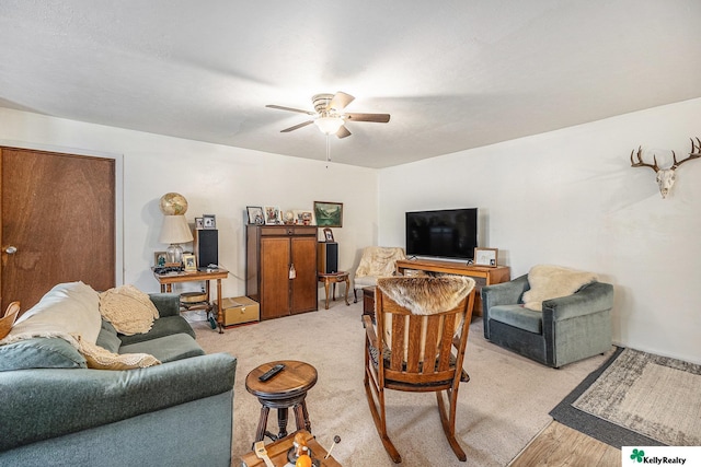 living area featuring a ceiling fan and light wood finished floors