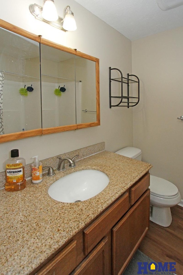 5201 N 9th Cir, Lincoln, NE 68521 - full bathroom with vanity, walk in shower, wood finished floors, and toilet