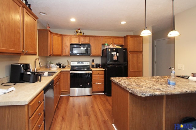 5201 N 9th Cir, Lincoln, NE 68521 - kitchen featuring a sink, brown cabinetry, black appliances, and light wood-type flooring