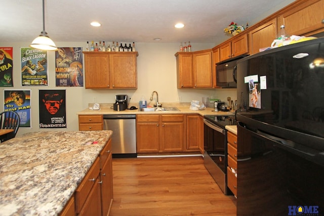 5201 N 9th Cir, Lincoln, NE 68521 - kitchen featuring brown cabinetry, a sink, black appliances, and light wood finished floors