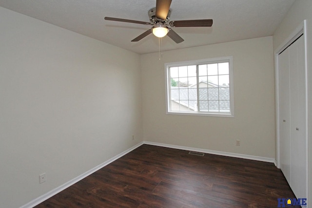 5203 N 9th Cir, Lincoln, NE 68521 - unfurnished bedroom with dark wood-type flooring, baseboards, ceiling fan, and a closet