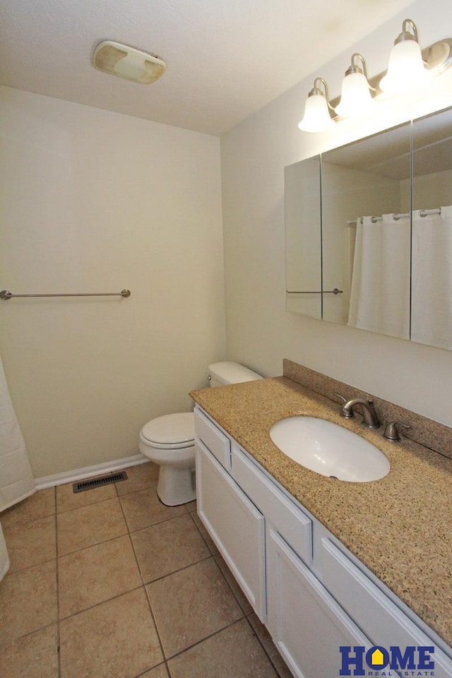 5203 N 9th Cir, Lincoln, NE 68521 - bathroom with a shower with curtain, visible vents, tile patterned floors, vanity, and toilet