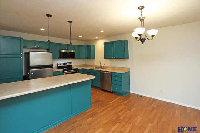 5203 N 9th Cir, Lincoln, NE 68521 - kitchen featuring visible vents, light countertops, a sink, a notable chandelier, and stainless steel appliances