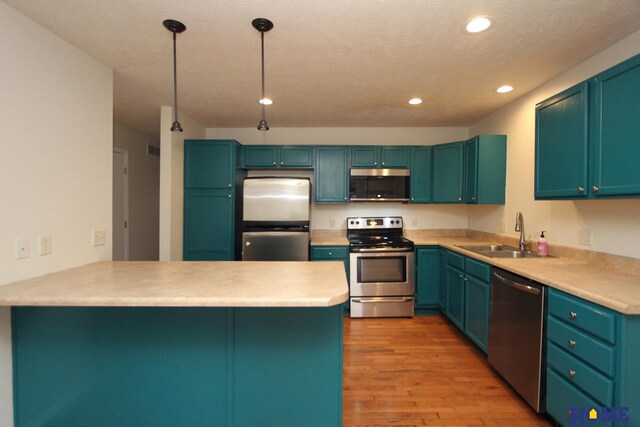 5203 N 9th Cir, Lincoln, NE 68521 - kitchen with a sink, light wood-style floors, stainless steel appliances, recessed lighting, and a peninsula