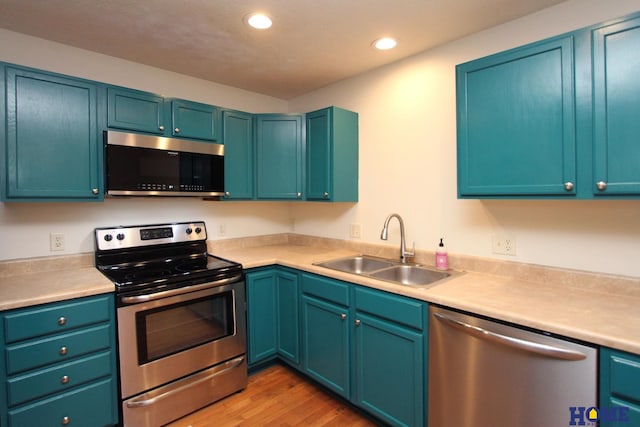 5203 N 9th Cir, Lincoln, NE 68521 - kitchen featuring recessed lighting, a sink, light wood-style floors, light countertops, and appliances with stainless steel finishes