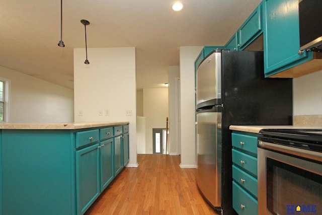 5203 N 9th Cir, Lincoln, NE 68521 - kitchen featuring light countertops, light wood-style flooring, hanging light fixtures, and stainless steel appliances