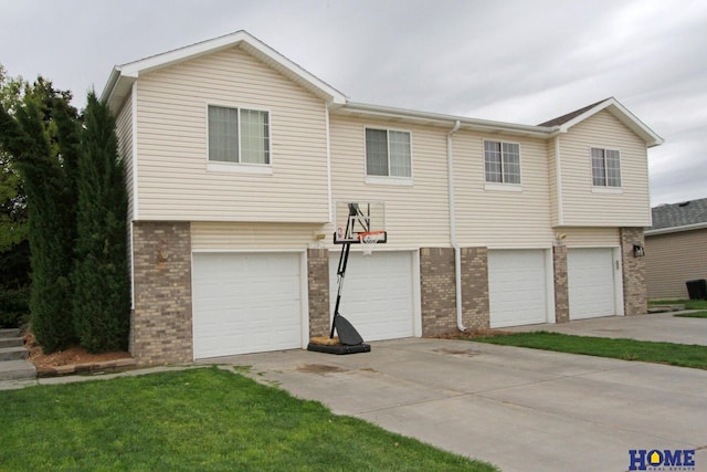 5203 N 9th Cir, Lincoln, NE 68521 - view of front of house featuring concrete driveway, a garage, and brick siding