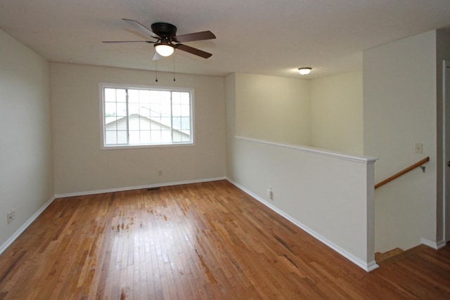 5203 N 9th Cir, Lincoln, NE 68521 - spare room featuring baseboards, a ceiling fan, and wood finished floors