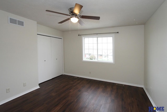 5203 N 9th Cir, Lincoln, NE 68521 - unfurnished bedroom with a closet, baseboards, visible vents, and dark wood-type flooring