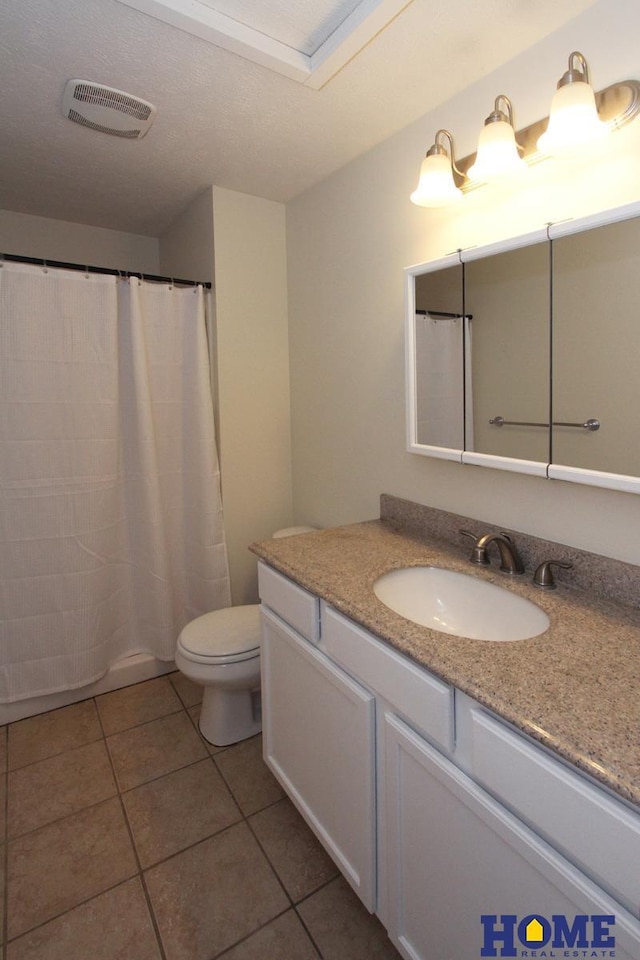 5203 N 9th Cir, Lincoln, NE 68521 - bathroom featuring vanity, toilet, tile patterned floors, a shower with curtain, and visible vents