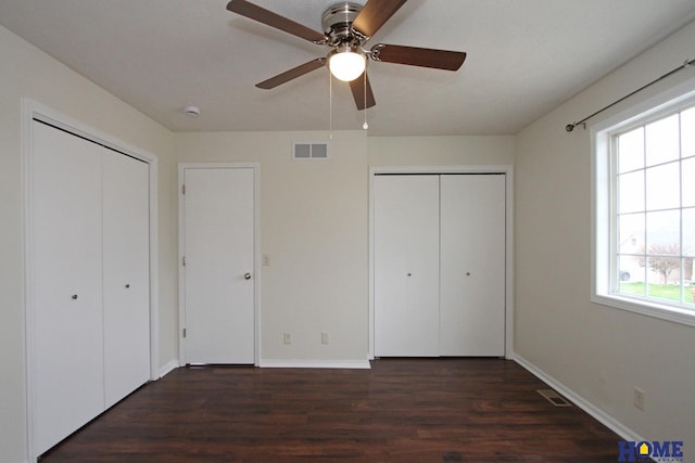 5203 N 9th Cir, Lincoln, NE 68521 - unfurnished bedroom with multiple closets, baseboards, wood finished floors, and visible vents