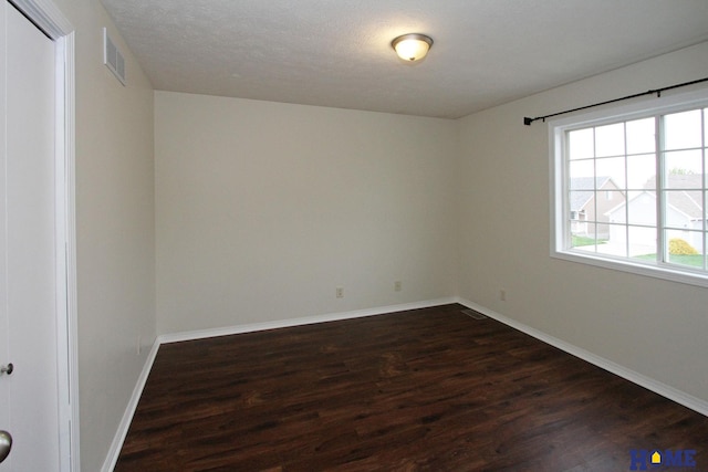 5203 N 9th Cir, Lincoln, NE 68521 - spare room featuring baseboards, dark wood-style flooring, and visible vents