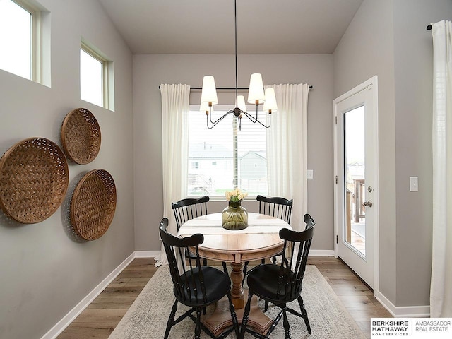 7911 N 149th St, Bennington, NE 68007 - dining room with baseboards, light wood-style flooring, and a chandelier
