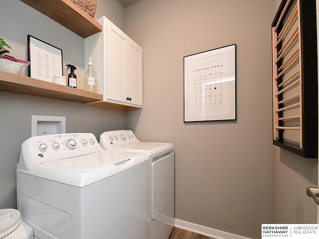 7911 N 149th St, Bennington, NE 68007 - laundry room with independent washer and dryer, baseboards, radiator, wood finished floors, and cabinet space