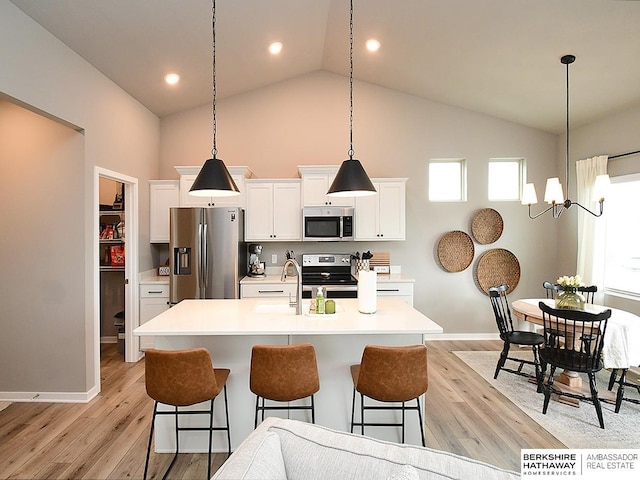 7911 N 149th St, Bennington, NE 68007 - kitchen featuring stainless steel appliances, an island with sink, an inviting chandelier, white cabinets, and baseboards