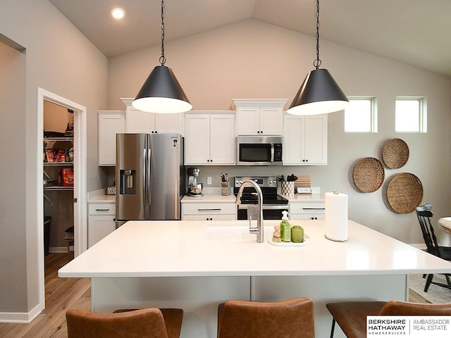 7911 N 149th St, Bennington, NE 68007 - kitchen featuring light wood-type flooring, a breakfast bar, white cabinetry, and appliances with stainless steel finishes