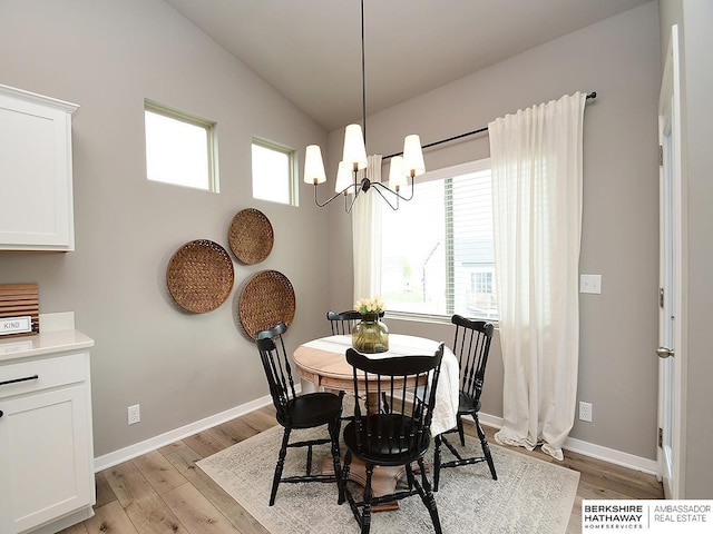 7911 N 149th St, Bennington, NE 68007 - dining space featuring light wood finished floors, lofted ceiling, baseboards, and a chandelier