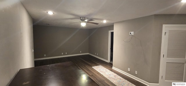 interior space with baseboards, ceiling fan, recessed lighting, and dark wood-type flooring
