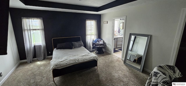 carpeted bedroom with baseboards and multiple windows