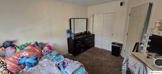 bedroom with dark colored carpet and a closet
