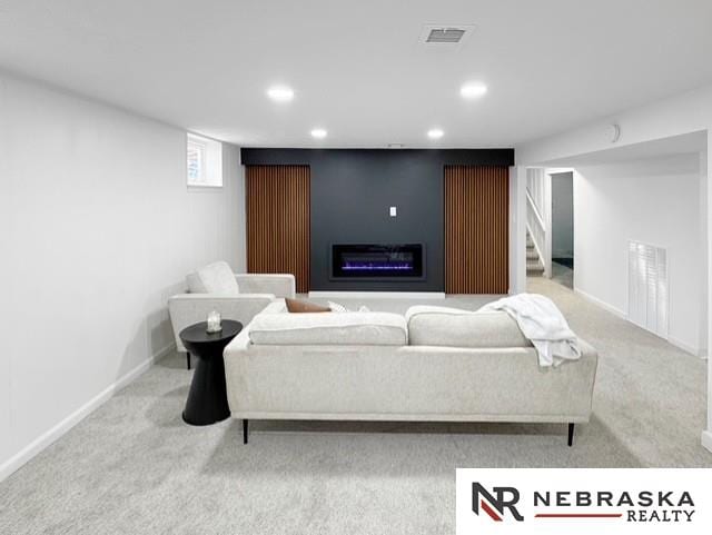 1816 S 49th St, Lincoln, NE 68506 - living room featuring a glass covered fireplace, carpet, recessed lighting, and visible vents
