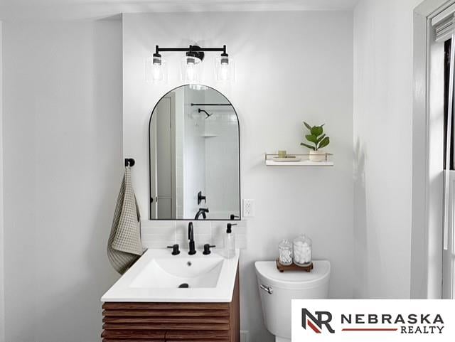 1816 S 49th St, Lincoln, NE 68506 - bathroom with vanity, backsplash, and toilet