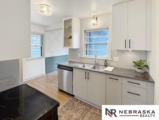 1816 S 49th St, Lincoln, NE 68506 - kitchen featuring white cabinetry, a sink, black / electric stove, and dishwasher