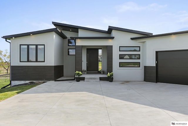 contemporary home featuring a garage and stucco siding