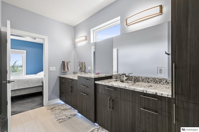 ensuite bathroom with baseboards, ensuite bathroom, and vanity