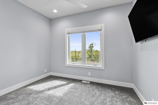 empty room featuring recessed lighting, baseboards, dark carpet, and visible vents