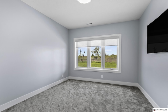 carpeted empty room with baseboards and visible vents