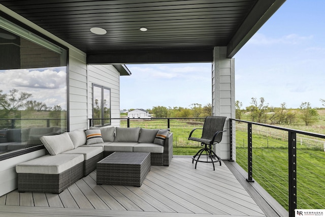 wooden deck with a lawn and an outdoor hangout area