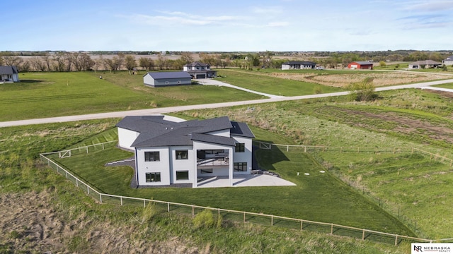 birds eye view of property with a rural view