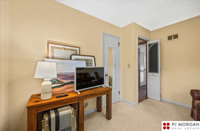 carpeted home office with baseboards and visible vents