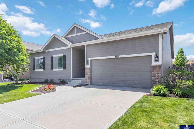 single story home featuring concrete driveway, stone siding, an attached garage, and a front lawn