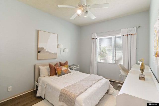 bedroom featuring wood finished floors, baseboards, and a ceiling fan