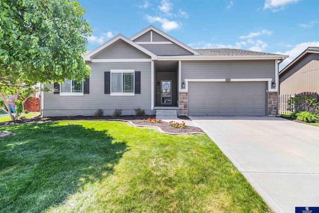 view of front of house featuring an attached garage, driveway, and a front yard