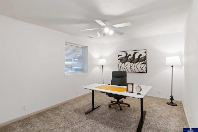 home office featuring carpet flooring, ceiling fan, and baseboards