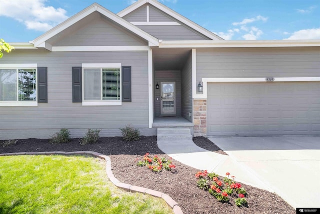 view of front of property featuring concrete driveway, an attached garage, and a front lawn