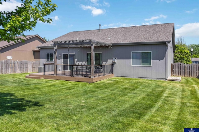 rear view of property featuring a pergola, a wooden deck, and a shingled roof