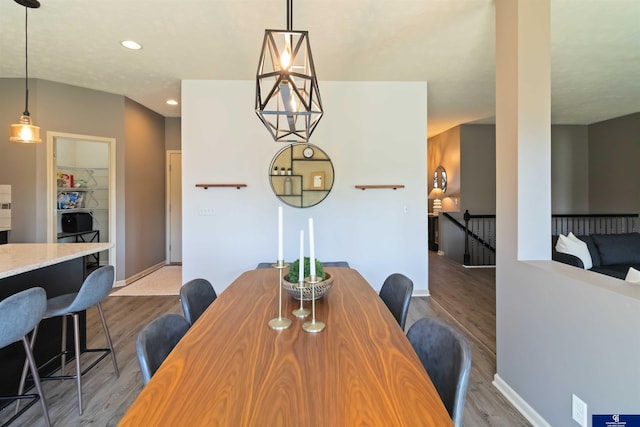 dining area with wood finished floors, recessed lighting, and baseboards