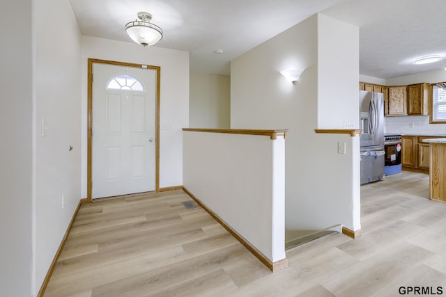 entrance foyer featuring baseboards and light wood-style flooring