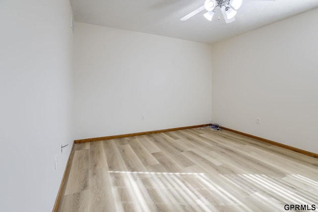 spare room with light wood-style floors, baseboards, and ceiling fan